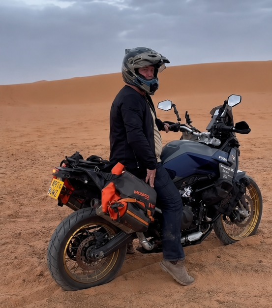 On the bike in the Sahara dunes.