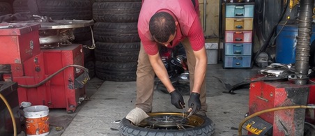 Roadside tire repair in a small garage.